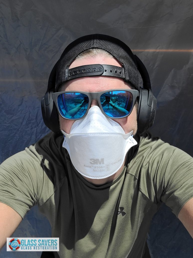 Professional glass polishing equipment set up for scratch removal in occupied commercial office